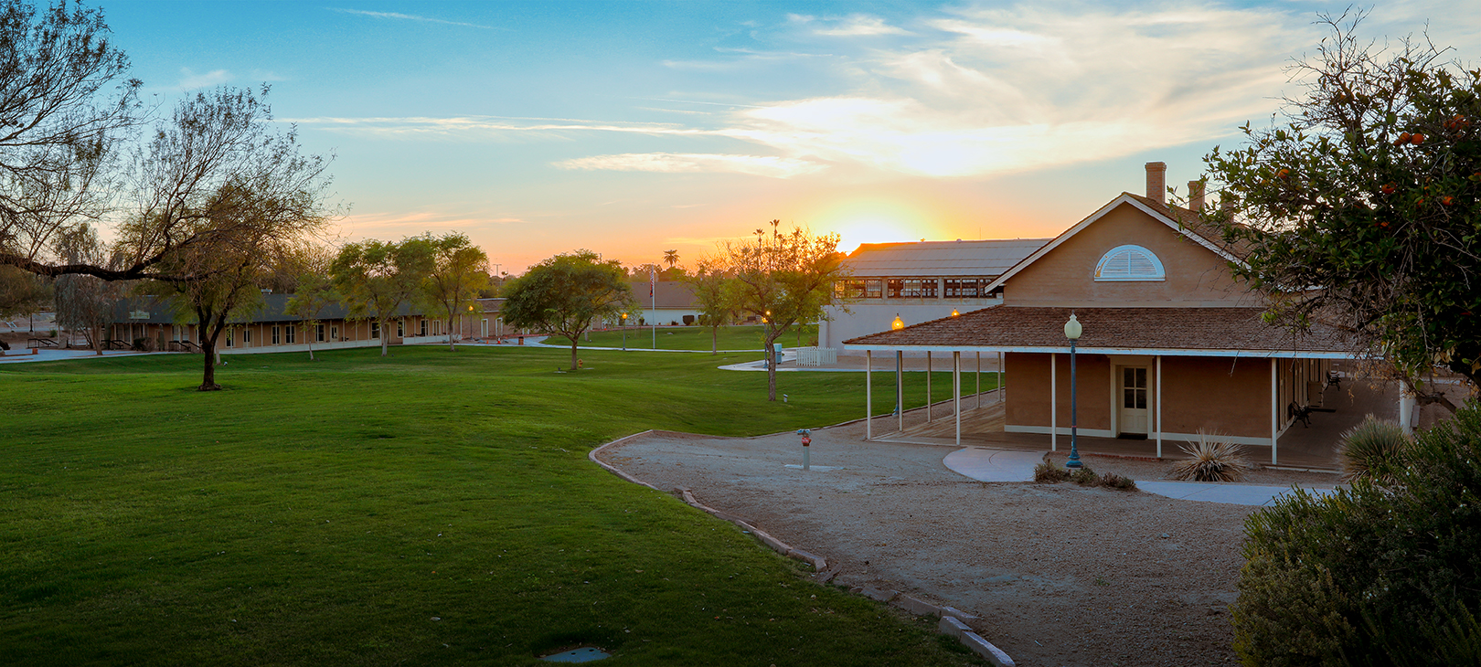 The sun rises over the lawn at Colorado River State Historic Park