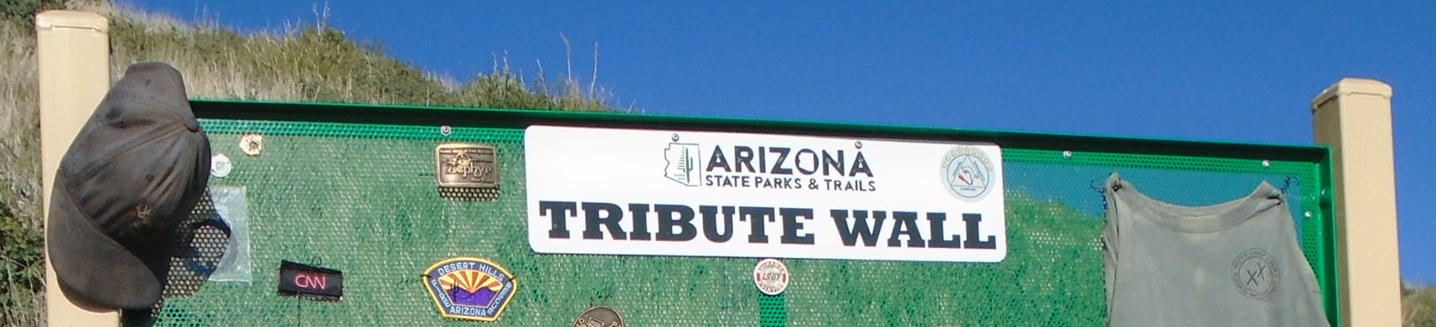 Visitors leave tokens of appreciation and items of sentiment at the Tribute Wall near the park entrance.