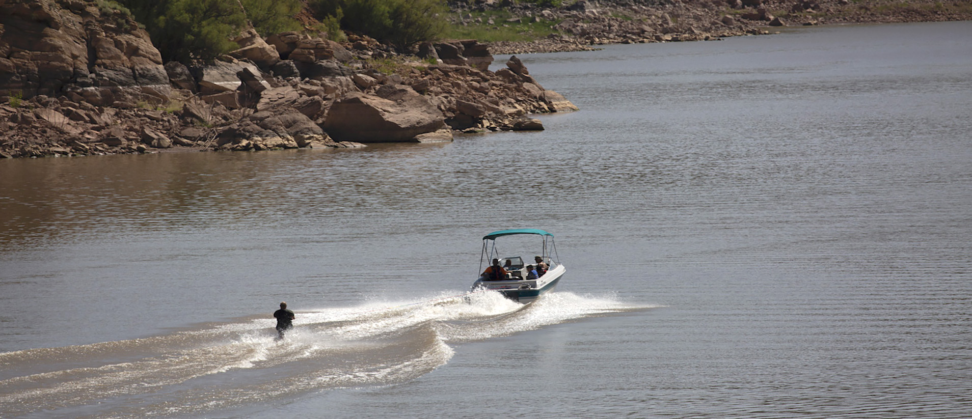 A person waterskis through the lake