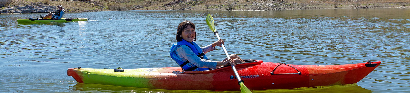 A child kayaking in a secluded cove of Alamo Lake.
