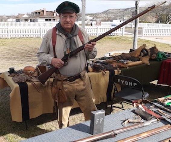 Man in mountain man clothing holding a rifle